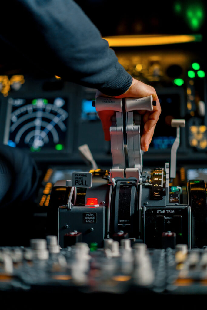 Close up of a pilot's hand pressing the throttle in the cockpit